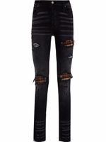 AMIRI jean skinny à finitions effilochées - Noir