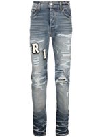 AMIRI jean skinny à effet usé - Bleu