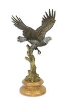 A BRONZE SCULPTURE OF AN EAGLE IN A FLIGHT