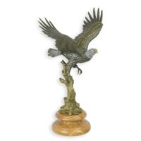 A BRONZE SCULPTURE OF AN EAGLE IN A FLIGHT