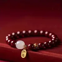 Elastische Rode Kralen Armband met Chinese Geluks Boon en Gouden Geluksbedel - Sieraden - Spiritueelboek.nl