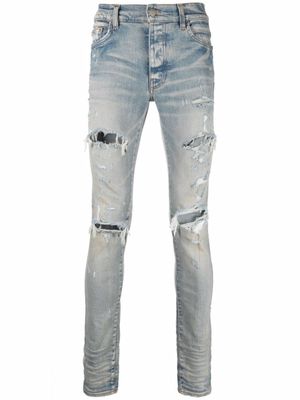 AMIRI jean skinny à effet usé - Bleu