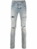 AMIRI jean skinny à effet usé - Bleu