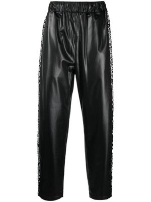 Junya Watanabe Comme des Garçons Pre-Owned x Keith Haring pantalon de jogging à imprimé graphique - Noir