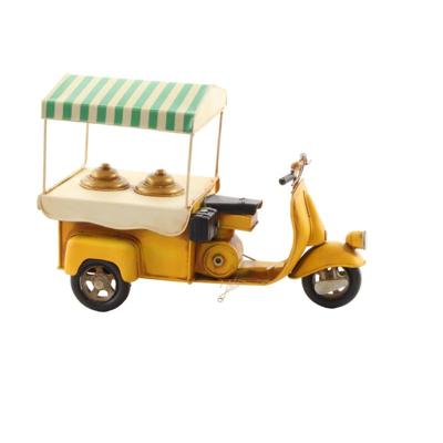 A TIN MODEL OF AN ICE CREAM CART