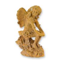 A RUSTY CAST IRON FIGURINE OF A SITTING FAIRY