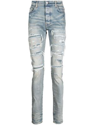 AMIRI jean skinny à effet usé - Bleu