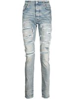 AMIRI jean skinny à effet usé - Bleu