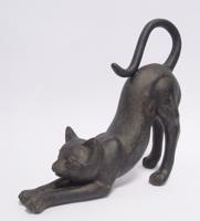 A RESIN FIGURINE OF A STRETCHING CAT