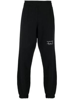 Martine Rose pantalon de jogging à logo imprimé - Noir