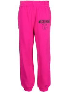 Moschino pantalon de jogging à logo imprimé - Rose